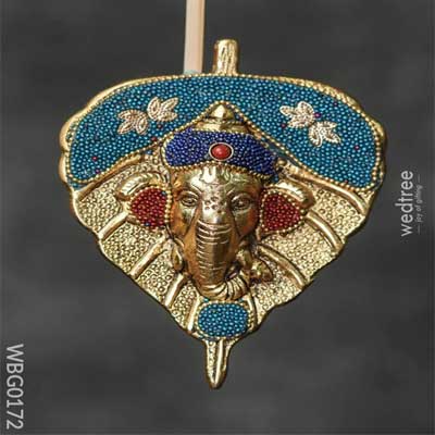White Metal Leaf Ganesha Face with Colourful Beads White Metal Leaf Ganesha Face with Colourful Beads