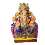 MH Ganapathy Colourful -Clay – 6 Inch – Left Trunk Colorful Ganesha idol wearing a jeweled crown and ornate jewelry, seated on a yellow base.