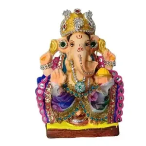 Colorful Ganesha idol wearing a jeweled crown and ornate jewelry, seated on a yellow base.